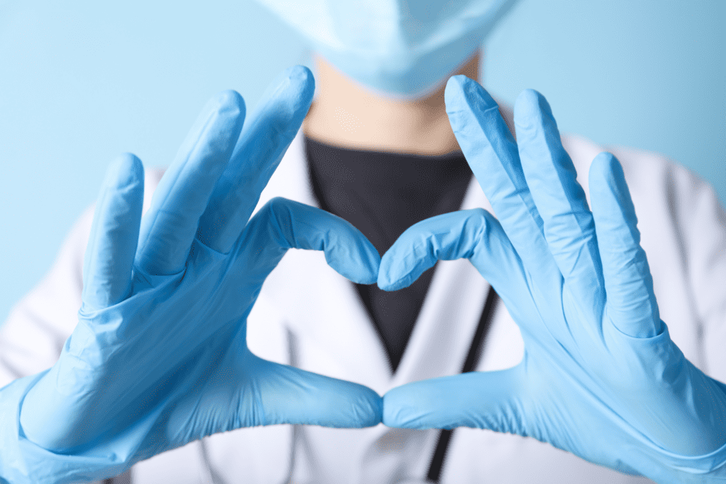 a nurse making a heart with her hands